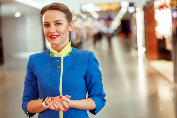 Vidám női légitársaság munkavállaló áll a repülőtér terminál - Fotó, kép