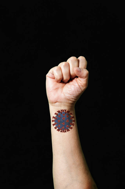 Fight Against Covid-19 raised fist symbol  - Photo, Image