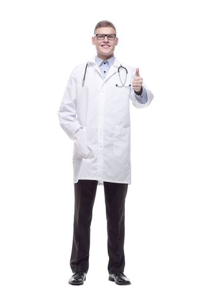 confident young doctor with a stethoscope. isolated on a white - Фото, изображение