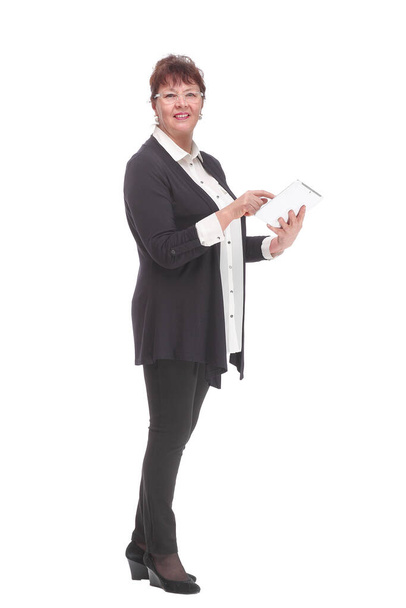 Happy senior woman standing, holding tablet computer, looking at camera. - 写真・画像