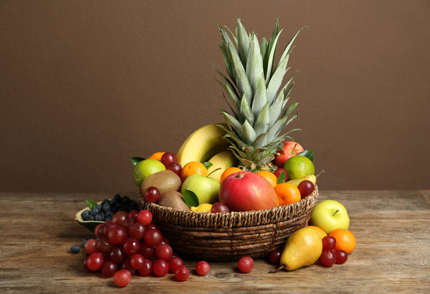 Assortment of fresh exotic fruits on wooden table - Photo, Image