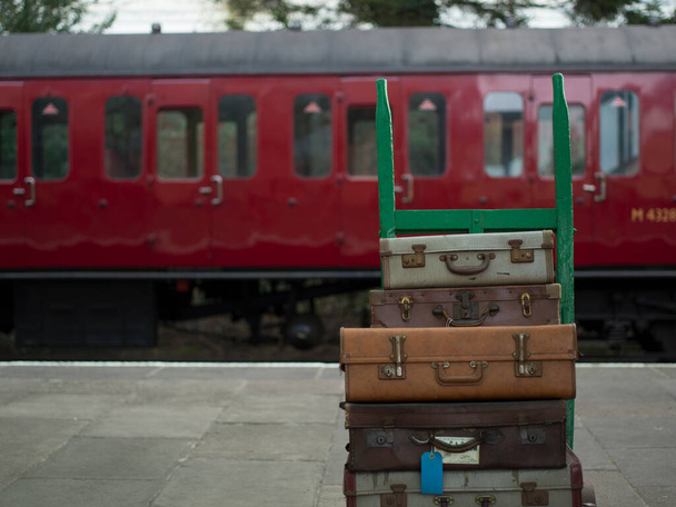 Great Central Railway, Loughborough, Leicestershire, UK, January 28, 2022, View of porters trolley with old-fashion cases and luggage - Фото, изображение