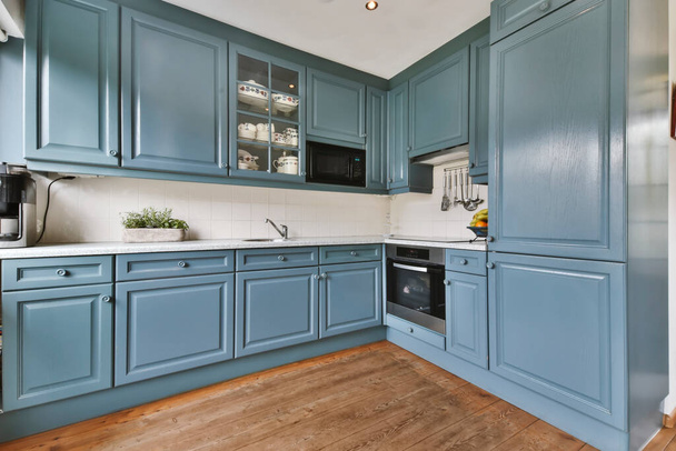 Amazing kitchen with a blue kitchen set - Fotoğraf, Görsel