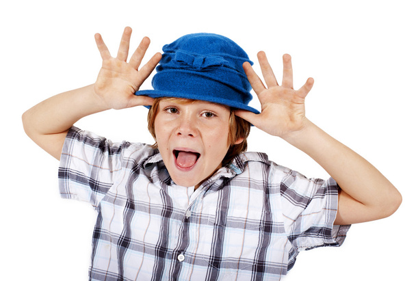 blond boy with blue hat making faces - 写真・画像