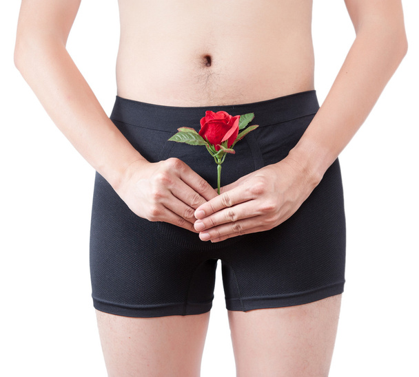 Close up of man on black boxer underware  holding red rose isolated - Foto, afbeelding