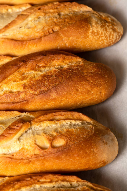 A closeup background of smaller French bread baguettes. - Foto, afbeelding
