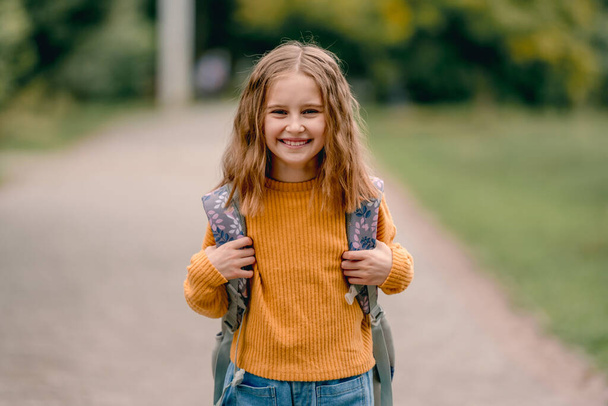 Schoolgirl with backpack outdoors - Φωτογραφία, εικόνα