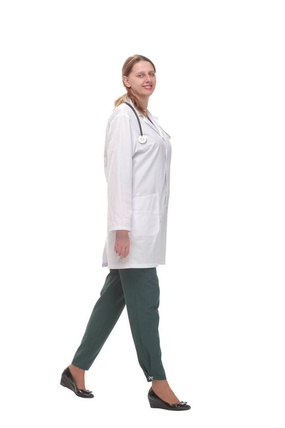 Full length portrait of medical doctor woman going sideways - Фото, зображення