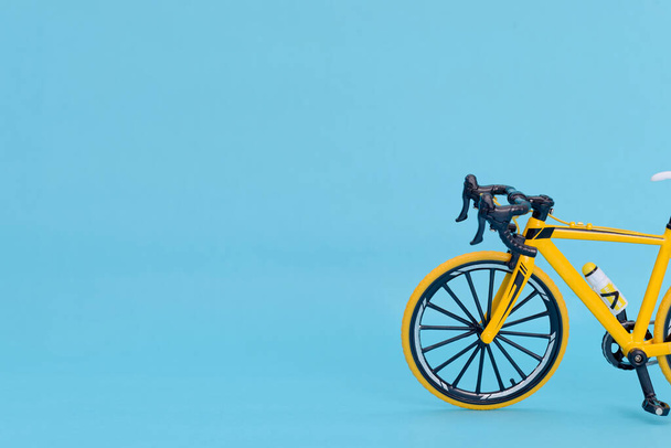 Yellow mountain bike on a blue background. - Photo, Image
