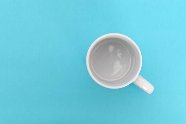 White mug on a blue background Mug isolated. - Photo, Image