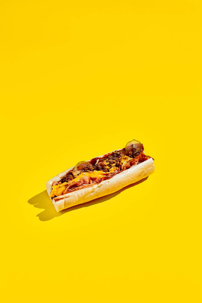 Beef cheesesteak in minimal style. American fast food in yellow background with shadow. Philly steak sandwich trendy concept. Junk food in colour background - Foto, immagini