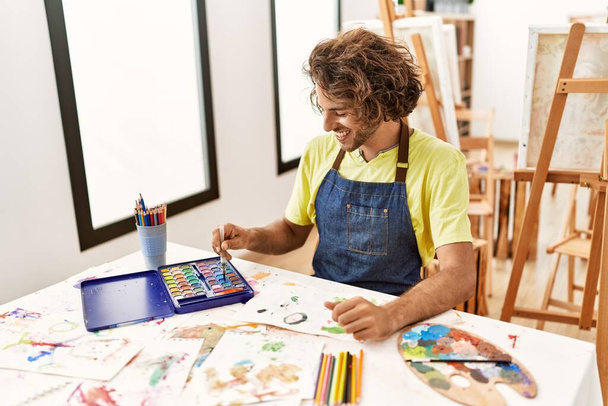 Young hispanic artist man smiling happy drawing at art studio. - Valokuva, kuva