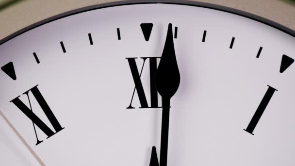 White wall clock tells the time 12 o'clock. It's time to relax  and have lunch. - Footage, Video