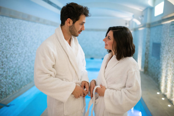 Young couple having fun in an indoor pool - Photo, image