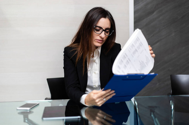 Businesswoman reading important business papers - Photo, Image