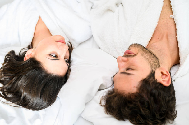 Young couple looking at each other deeply under the blankets - Foto, Bild