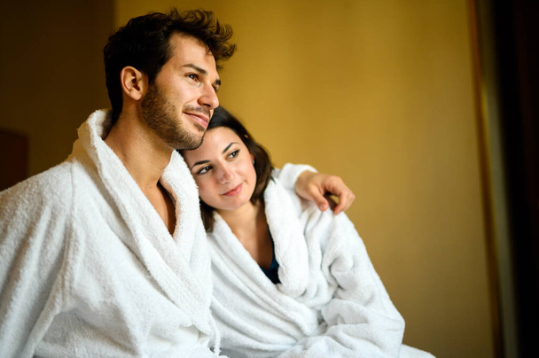Romantic couple enjoying honeymoon and wellness treatments in a hotel suite - Foto, afbeelding