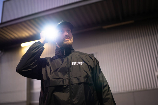 Security Guard Walking Building Perimeter With Flashlight At Night - Photo, Image
