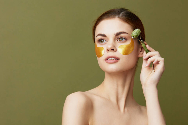 pretty woman patches rejuvenation skin care fun after shower facial massage green background - Φωτογραφία, εικόνα