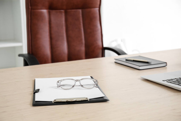 Clipboard and glasses on office table - Photo, Image