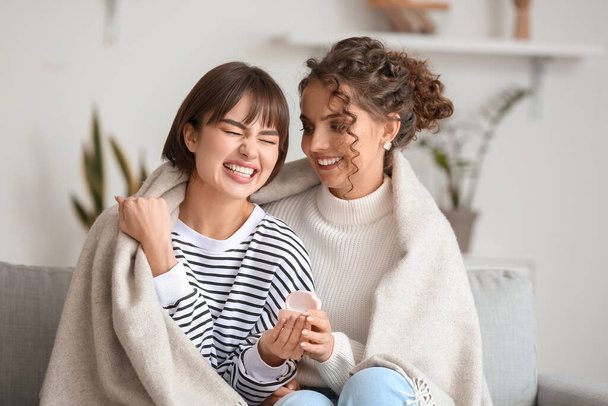 Happy engaged lesbian couple at home - Fotoğraf, Görsel
