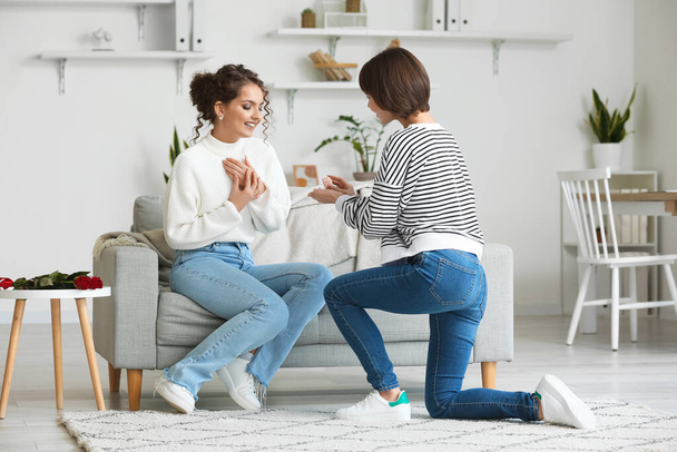 Young lesbian woman proposing to her girlfriend at home - Φωτογραφία, εικόνα