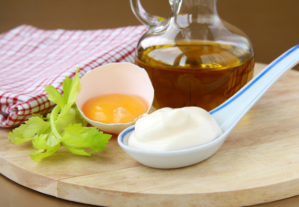 Mayonnaise with egg and olive oil on a wooden board - Photo, Image