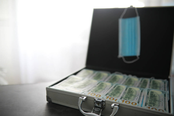 A metal suitcase filled American 100 dollar bills. Double exposure. Investment, bribe, corruption concept. - Photo, Image