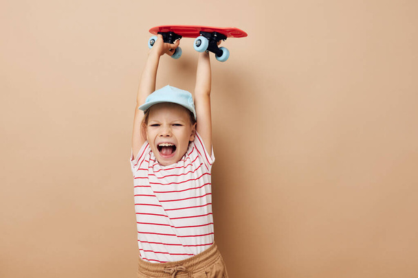 cute girl with a childrens skateboard in hand smile Lifestyle unaltered - Foto, imagen