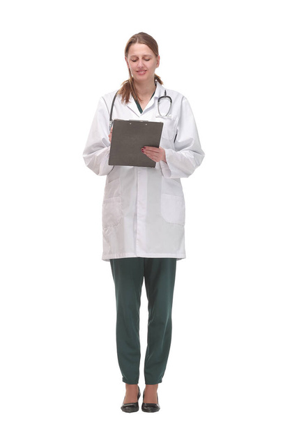 Happy smiling female doctor with stethoscope writing on clipboard - Foto, Bild
