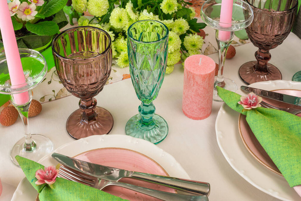 Romantic spring table setting for two with wine glasses, candles and flowers - Photo, Image