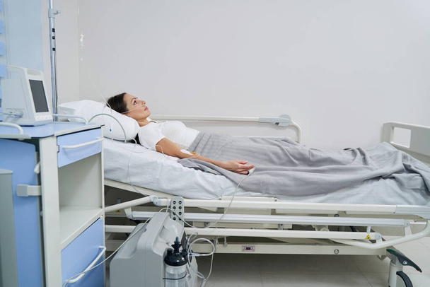 Caucasian female patient connected to oxygen concentrator - 写真・画像