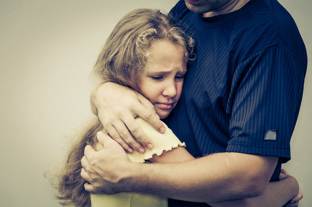 portrait of one sad daughter hugging his father - Fotografie, Obrázek