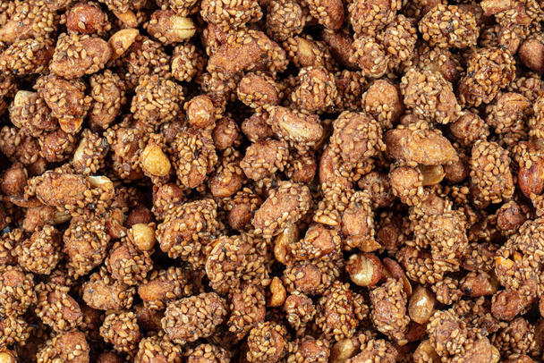 Honey with sesame peanuts (peanuts with sesame). Close-up view of brown colored peanuts and peanut collection. Concept groundnuts and Sesame, Sesame seeds. - Foto, Imagem