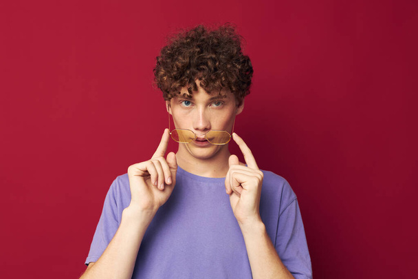 Young curly-haired man posing emotions close-up isolated background - Foto, Imagen