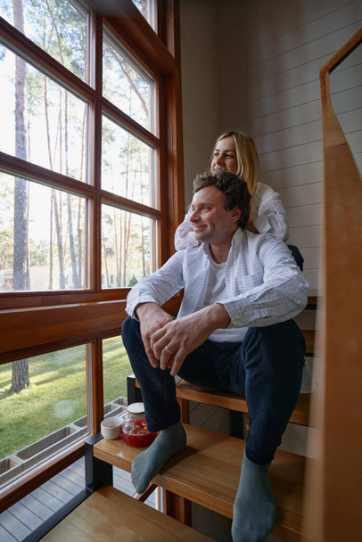 Positive delighted man being at home with wife - Foto, Imagem