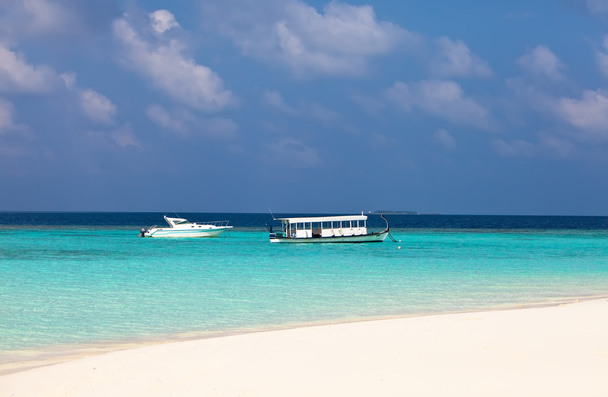 Maldives. A modern boat and a national boat at ocean - Photo, Image