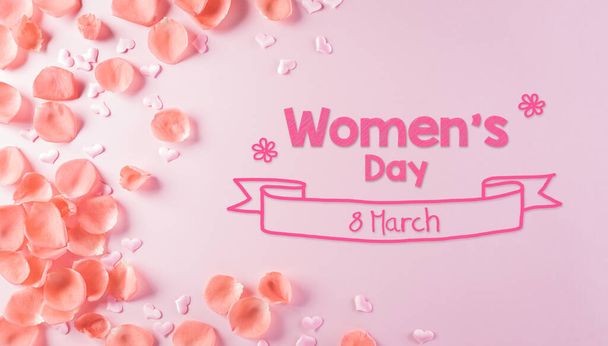 Happy Women's Day concept. Top view of roses flowers, heart and "Women's Day" text on pink pastel background. - Photo, Image