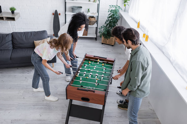high angle view of happy interracial friends playing table football  - Φωτογραφία, εικόνα