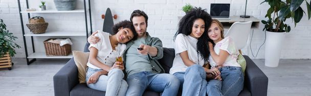 cheerful lesbian and heterosexual couples watching movie on sofa, banner - Valokuva, kuva