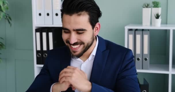 Young businessman smiling while working on laptop - Felvétel, videó