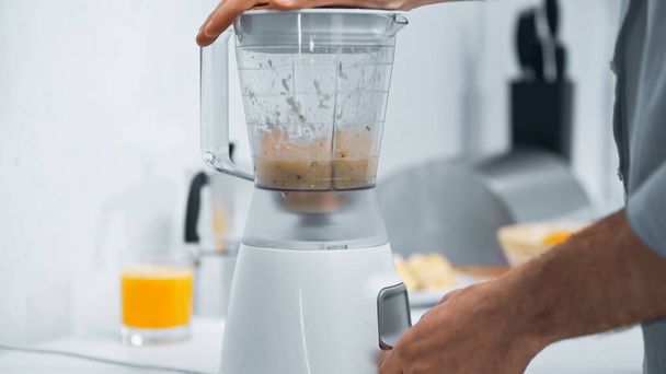 cropped view of man preparing smoothie in electric blender - Photo, Image