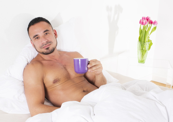 Man in bed with cup - Zdjęcie, obraz