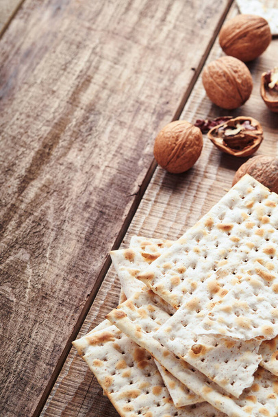 Matzah and walnut. Traditional ritual Jewish bread on old wooden rustic background. Passover food. Pesach Jewish holiday of Passover celebration concept. - Fotografie, Obrázek