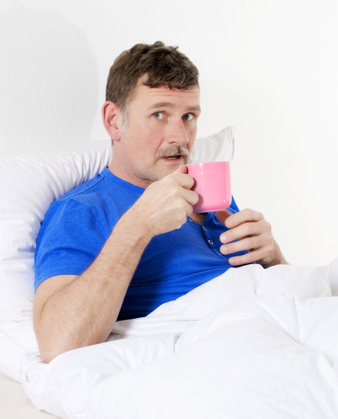 man in bed with cup - Photo, Image