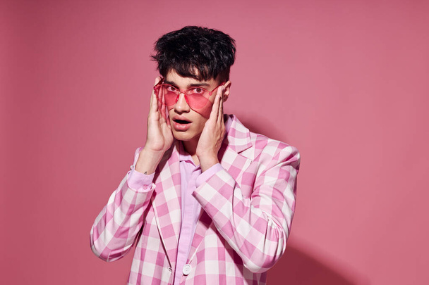 A young man plaid blazer pink glasses fashion modern style pink background unaltered - Фото, изображение