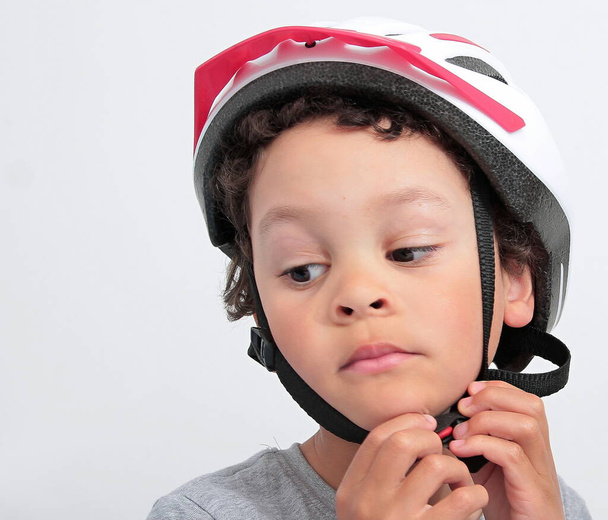 little child playing with a bicycle helmet stock photo - Zdjęcie, obraz