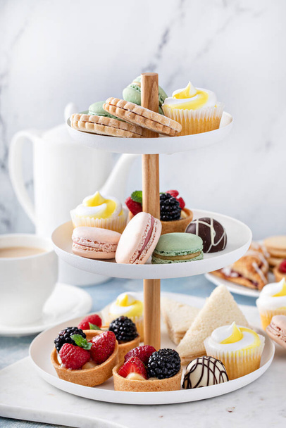 Spring or summer dessert table, three tiered tray with desserts - 写真・画像