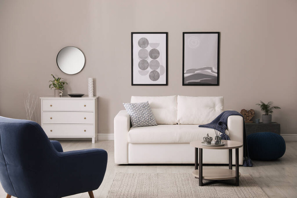Stylish living room interior with white sofa, armchair and small coffee table - Valokuva, kuva