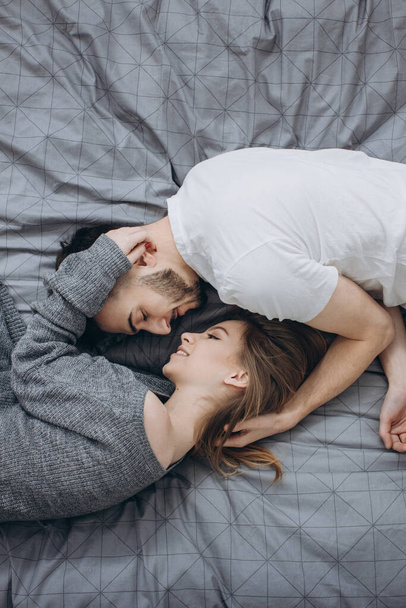 Sensual couple in bed cuddling - Фото, зображення